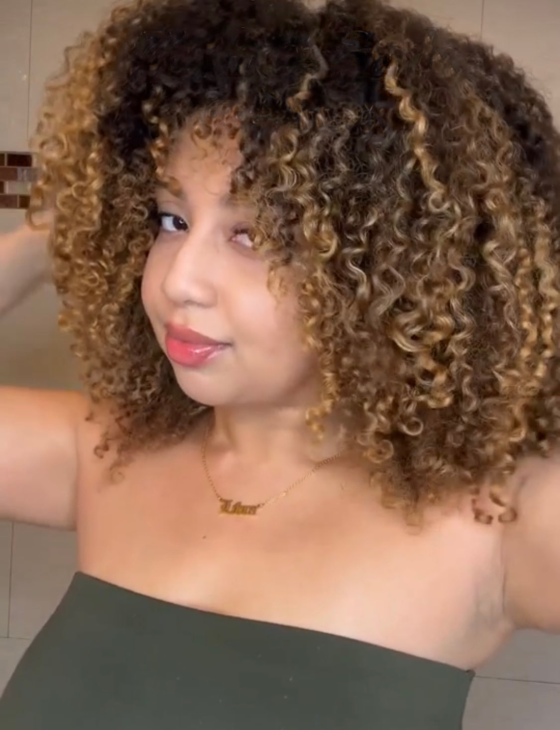 A woman showing her hair after using Curls Dynasty products.