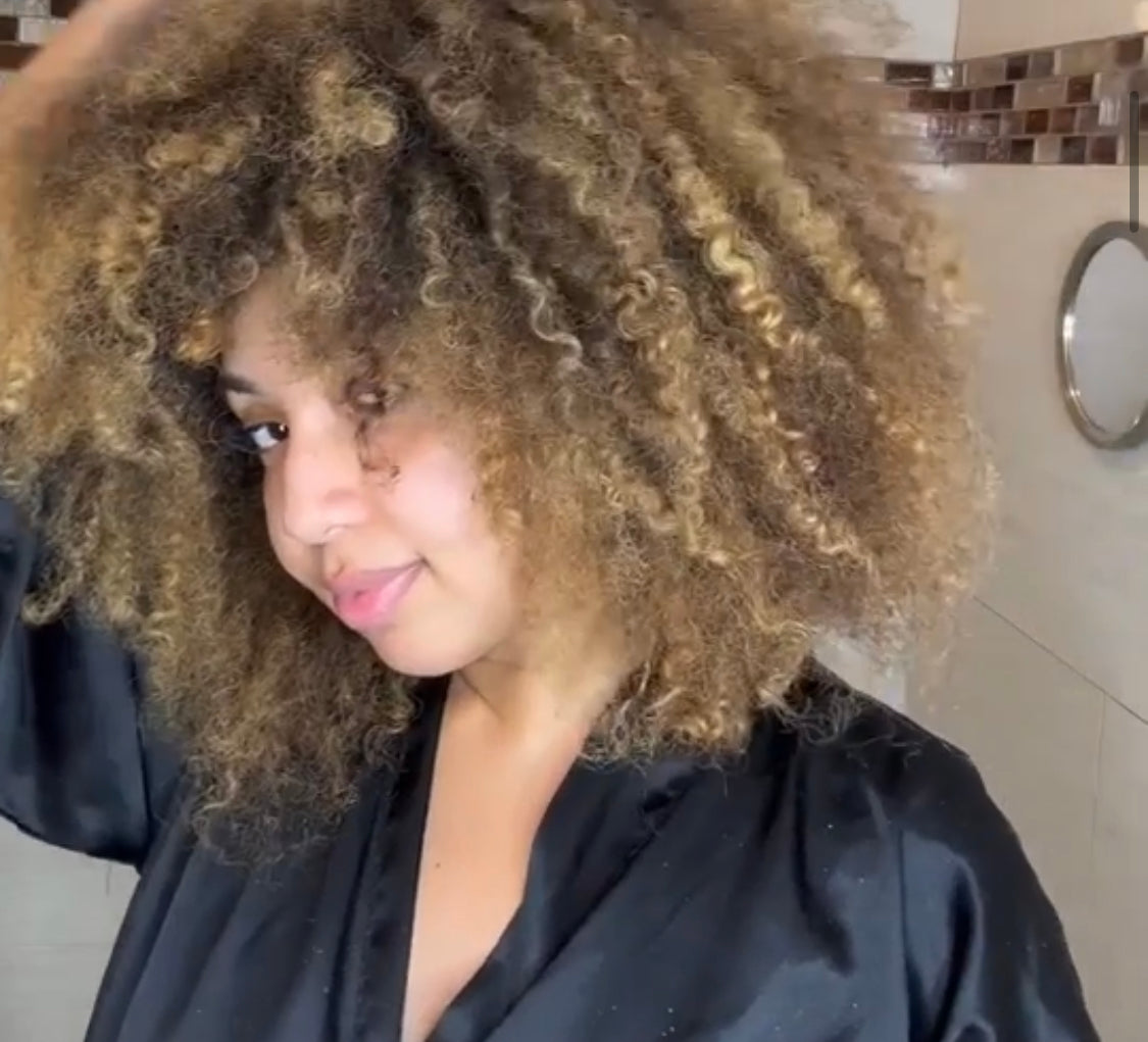 A woman showing her hair before using Curls Dynasty products.
